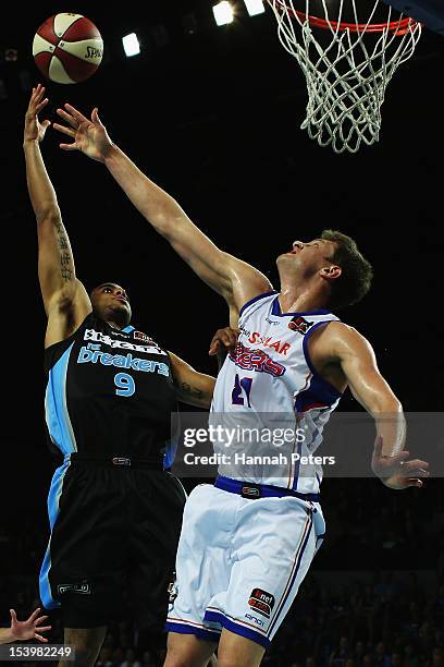 Daniel Johnson of Adelaide defends against Corey Webster of the Breakers during the round two NBL match between the New Zealand Breakers and the...