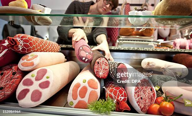 Artist Silvia Wald poses with sausage made of cloth at her fashion studio 'Aufschnitt' in Berlin, on October 10, 2012. Under the motto 'Fleshy Fluffy...