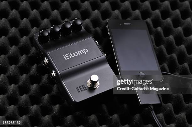 DigiTech iStomp programmable electric guitar effects pedal connected to an Apple iPhone 4S smartphone, photographed during a studio shoot for...