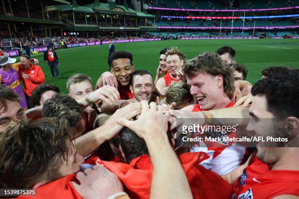 Swans head coach John Longmire is mobbed by Swans players after victory during the round 18 AFL match between Sydney Swans and Western Bulldogs at...
