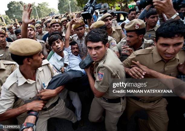 India Against Corruption activist Arvind Kejriwal is detained by police personnel during a protest against Union Law Minister Salman Khurshid over...