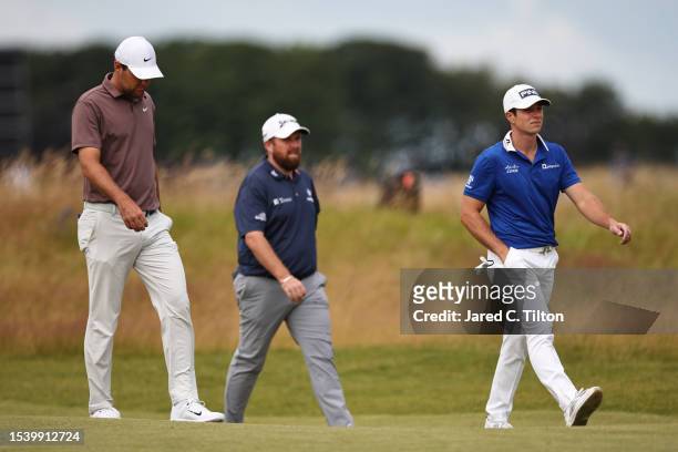 Scottie Scheffler of the United States, Shane Lowry of Ireland and Viktor Hovland of Norway walk on the 1st fairway during Day One of the Genesis...