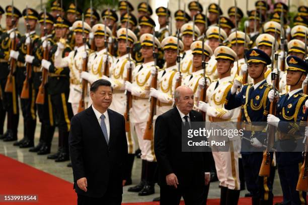 Algerian President Abdelmadjid Tebboune walks with Chinese President Xi Jinping during a welcome ceremony at the Great Hall of the People on July 18,...
