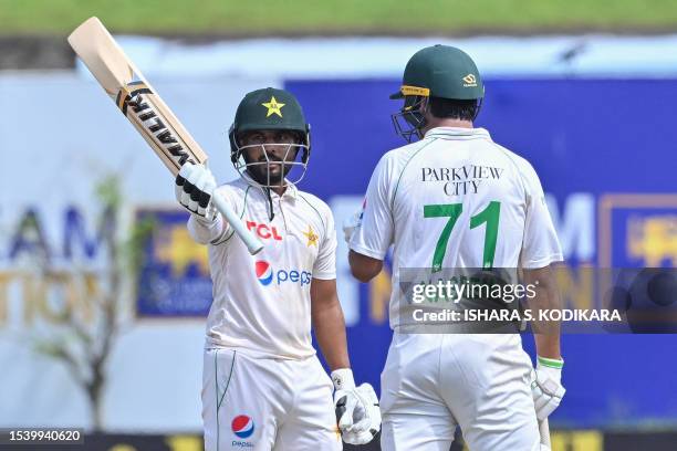 Pakistan's Saud Shakeel celebrates 150 runs as his teammate Naseem Shah watches during the third day of the first cricket Test match between Sri...