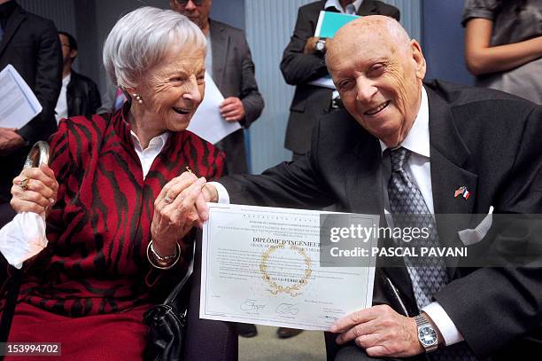 Sylvio Ferrera, a French-american aged 96 poses with his wife Irma after receiving his engineer degree from the director of the Enseeiht, one of...