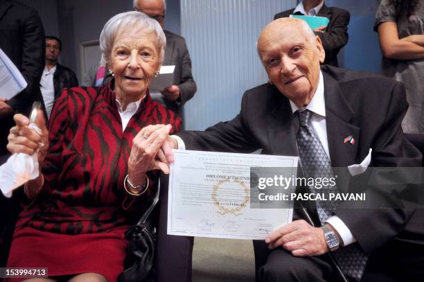 Sylvio Ferrera, a French-american aged 96 poses with his wife Irma after receiving his engineer degree from the director of the Enseeiht, one of...