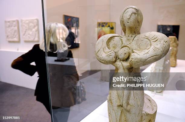 Woman passes by a plaster sculpture ""La vierge à l'enfant" by Russian-French painter Marc Chagall on October 12, 2012 at the Art and Industry museum...