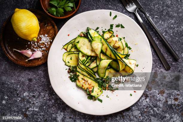 healthy vegan summer food, grilled zucchini
with garlic, parsley and lemon zest - courgette stock pictures, royalty-free photos & images