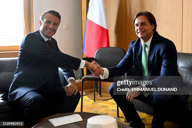 France's President Emmanuel Macron meets with Uruguay's President Luis Lacalle Pou on the sidelines of the second day of a summit of the European...