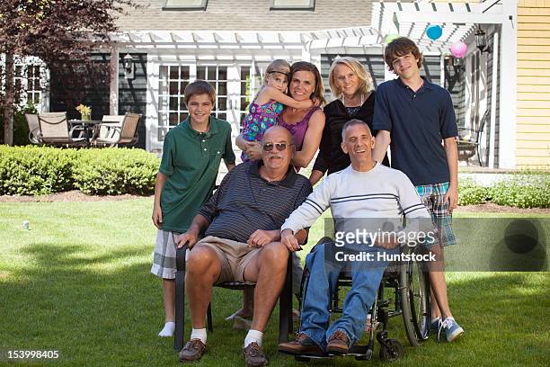 portrait of an extended family with a man with spinal cord injury in wheelchair - duxbury, massachusetts stock pictures, royalty-free photos & images