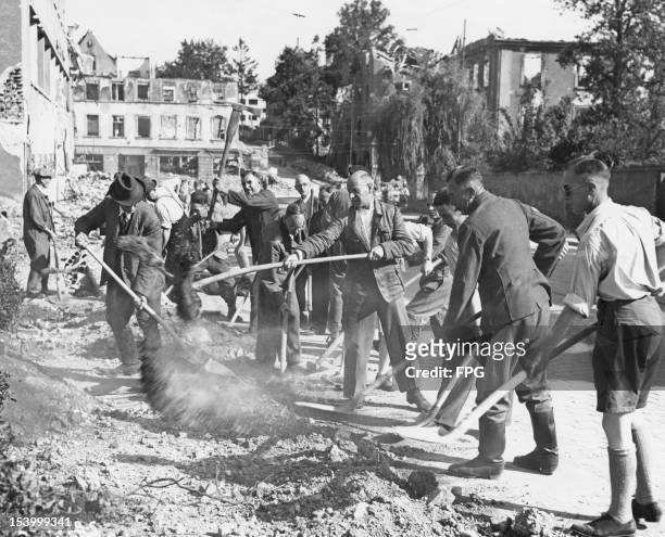 German civilians clearing rubble in Ulm, Germany, during the post-war Allied occupation of the country, 1949.