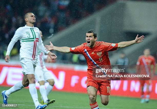 Russia's national football team player Aleksandr Kerzhakov celebrates scoring a goal during the FIFA 2014 World Cup qualifying match between Russia...