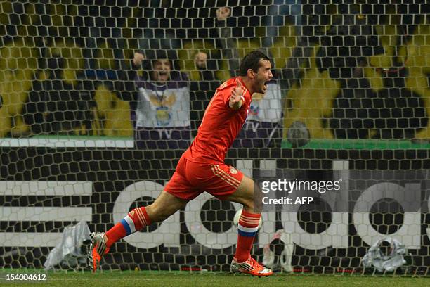 Russia's national football team player Aleksandr Kerzhakov celebrates after scoring a goal during the FIFA 2014 World Cup qualifying match between...