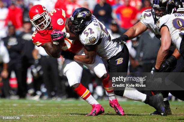 Cyrus Gray of the Kansas City Chiefs is knocked backwards by Ray Lewis of the Baltimore Ravens midway in the fourth quarter on October 07, 2012 at...
