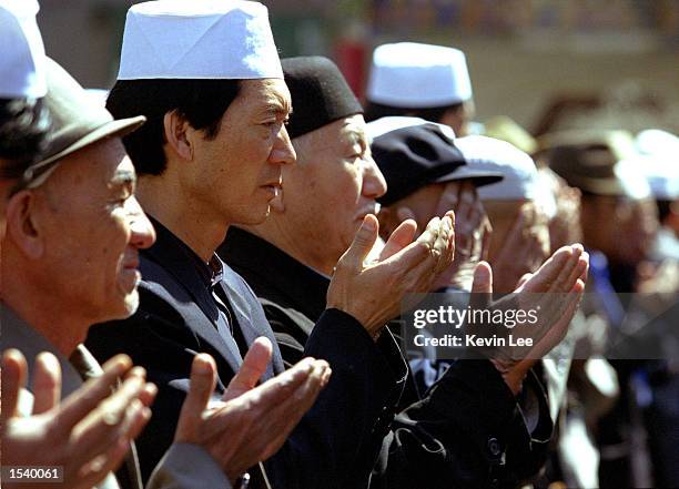 Muslim Uighur men pray at a funeral outside a mosque April, 21 2002 in Urumqi, Xinjiang Region, China. China has demanded the repatriation of Uighur...