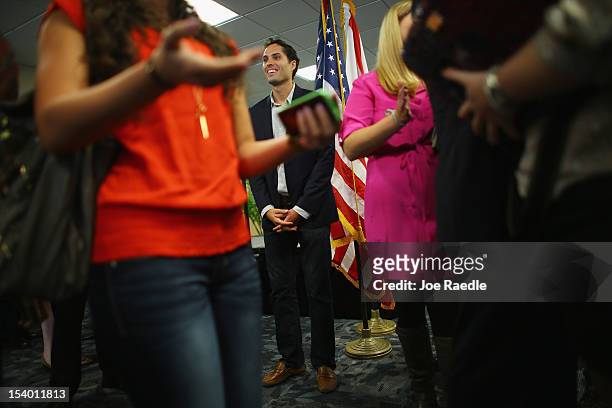 Craig Romney the son of Republican presidential candidate, former Massachusetts Gov. Mitt Romney greets people at a campaign rally for his father at...