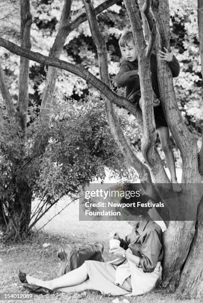 Folk musician Pete Seeger's wife and partner Toshi Seeger and their daughter, Tinya Seeger, relax backstage at the Newport Folk Festival in July,...