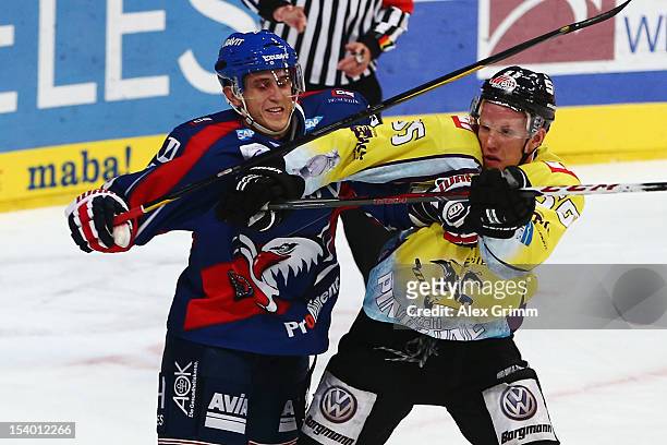 Marcel Goc of Mannheim fights with Christian Ehrhoff of Krefeld during the DEL match between Adler Mannheim and Krefeld Pinguine at SAP-Arena on...