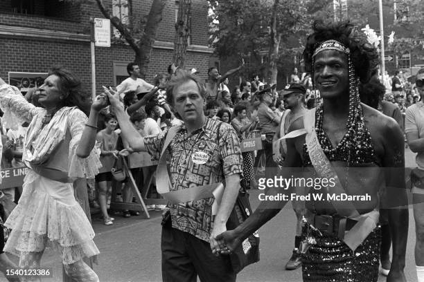 From second left, American gay liberation and transgender rights activists Sylvia Rivera , Jim Fouratt, and Marsha P Johnson hold hands as they march...