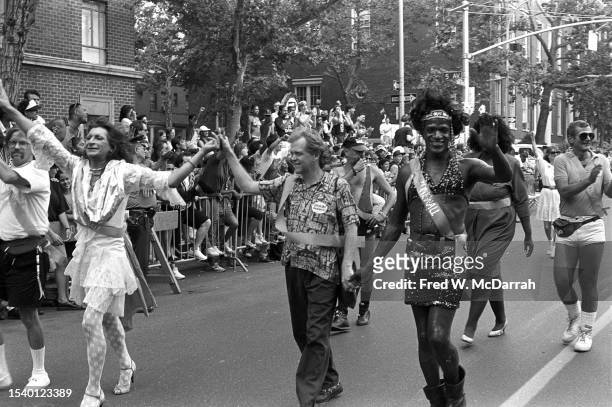 From left, American gay liberation and transgender rights activists Sylvia Rivera , Jim Fouratt, and Marsha P Johnson hold hands as they march...