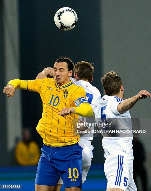 Swedish forward Zlatan Ibrahimovic vies with Faroe Islands's Rogvi Baldvinsson and Frodi Benjaminsen during the FIFA 2014 World Cup qualifier...