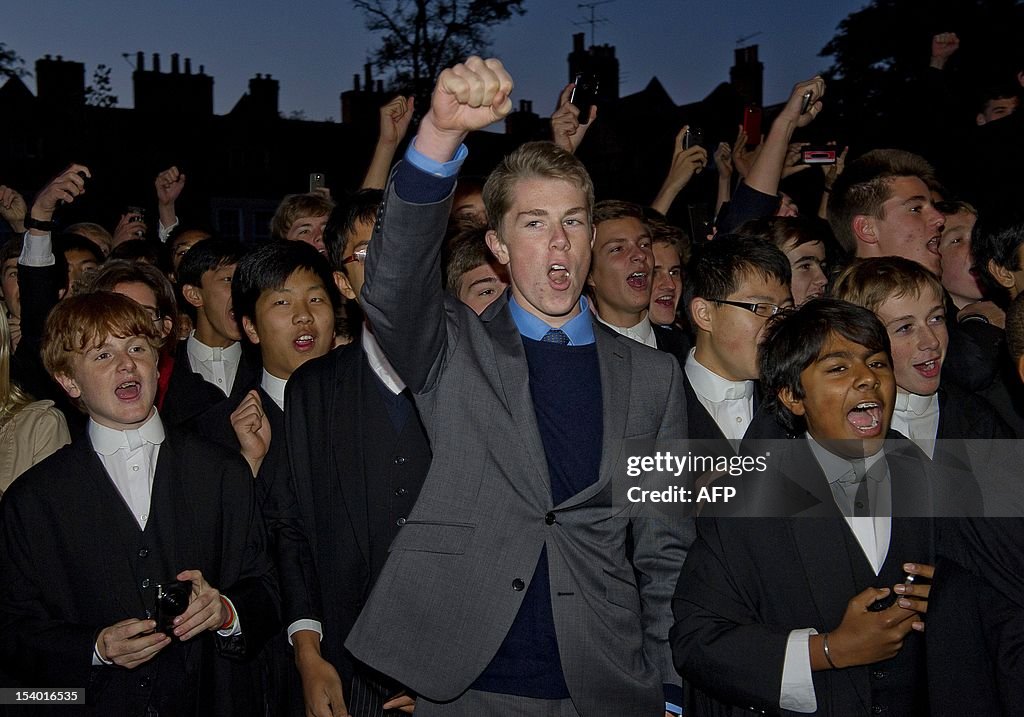 Pupils cheer for Queen Elizabeth II as she arrives at Eton College in