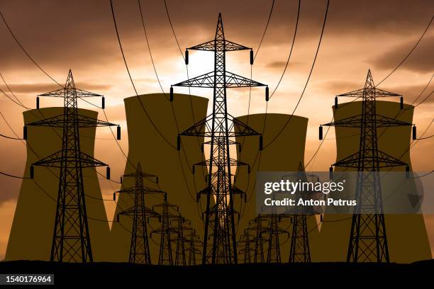 nuclear power plant and power lines on the background of sunset - energía nuclear fotografías e imágenes de stock