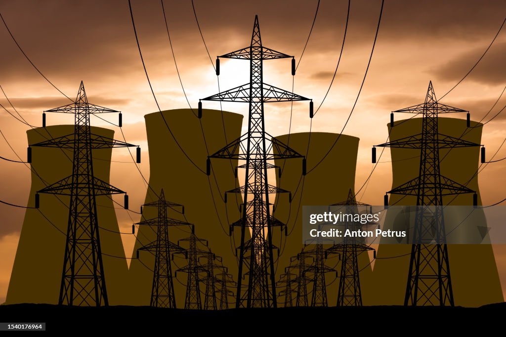 Nuclear power plant and power lines on the background of sunset