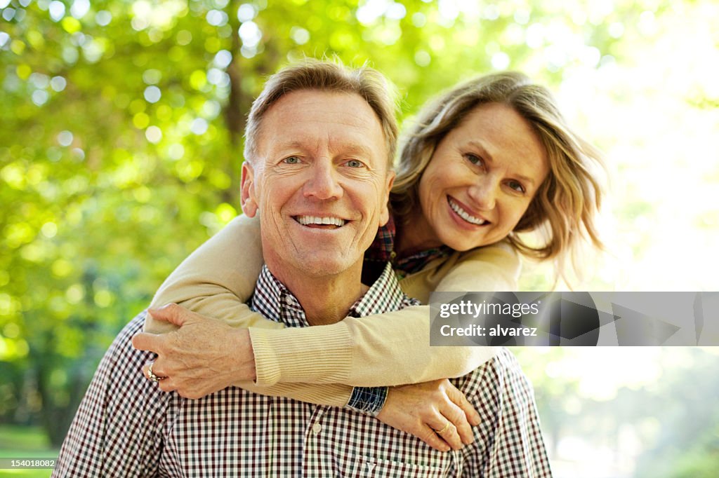 Man carrying his wife on piggy back