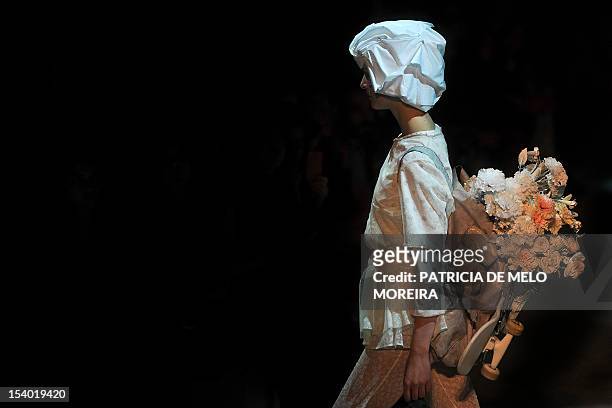 Model displays a Spring/Summer 2013 creation by Portuguese fashion designer Alexandra Moura during the 39th Edition of Moda Lisboa at Patio da Gale,...