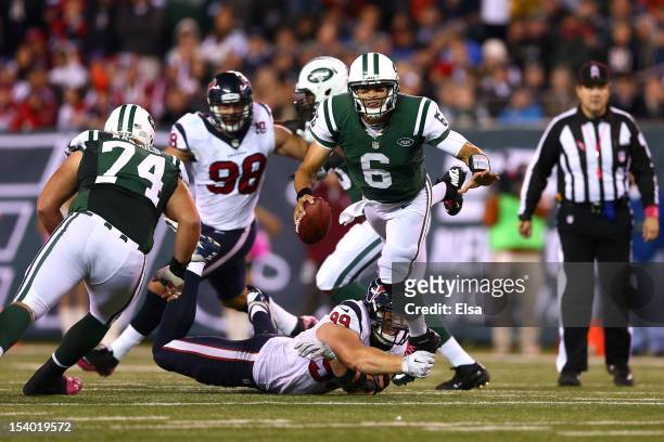 Mark Sanchez of the New York Jets is sacked by J.J. Watt of the Houston Texans in the fourth quarter at MetLife Stadium on October 8, 2012 in East...