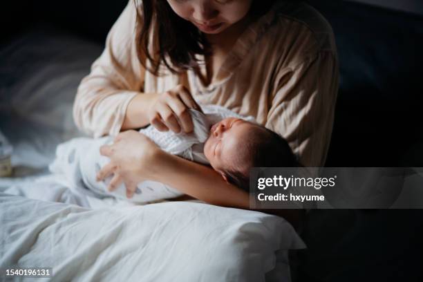 mother wipes the baby's mouth with a handkerchief - sleep hygiene stock pictures, royalty-free photos & images