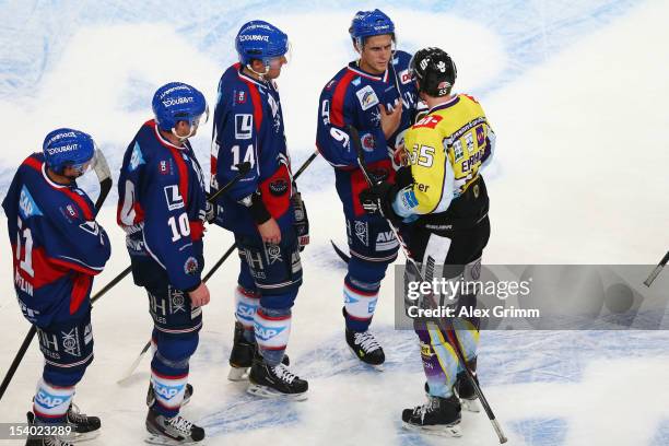 Christian Ehrhoff of Krefeld chats with Marcel Goc of Mannheim after the DEL match between Adler Mannheim and Krefeld Pinguine at SAP-Arena on...