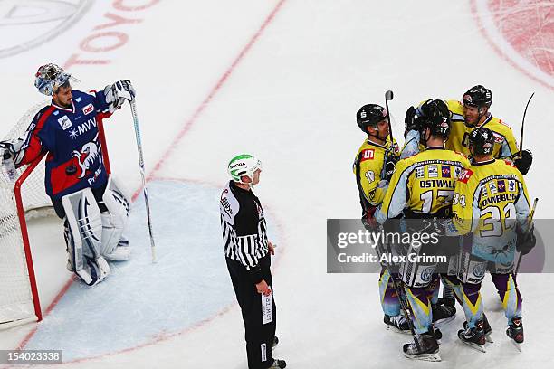 Elia Ostwald of Krefeld celebrates his team's fourth goal with team mates as goalkeeper Dennis Endras of Mannheim reacts during the DEL match between...