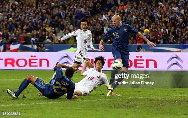 Shinji Kagawa of Japan scores the winning goal as Gael Clichy and Christophe Jallet of France fail to stop during the International Friendly match...