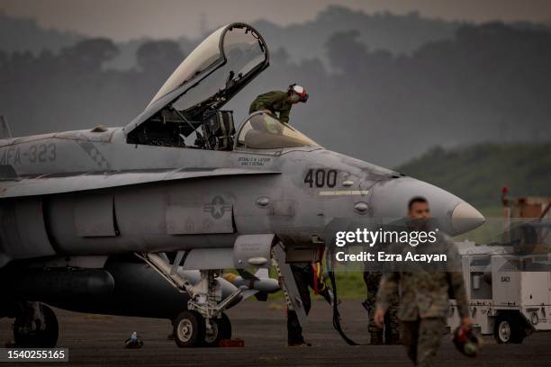 Marines prepare an F/A-18 Hornet fighter jet as they take part in the bi-annual Marine Aviation Support Activity 23 at the airport of a former US...