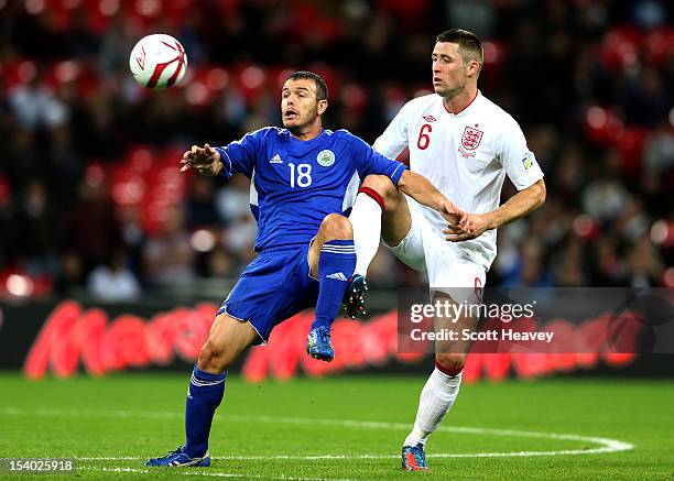 Gary Cahill of England competes for the ball with Andy Selva of San Marino during the FIFA 2014 World Cup Group H qualifying match between England...