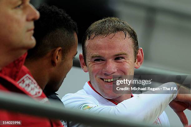Wayne Rooney of England smiles as he talks to Ashley Cole after being substituted during the FIFA 2014 World Cup Group H qualifying match between...