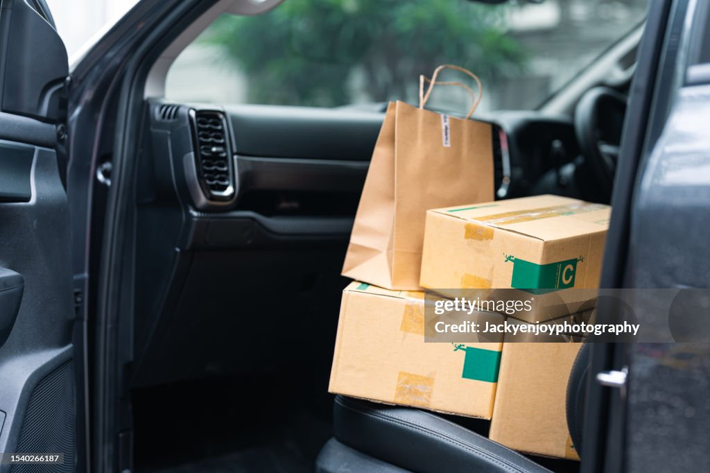 Stack of packages in a delivery car after mail delivery