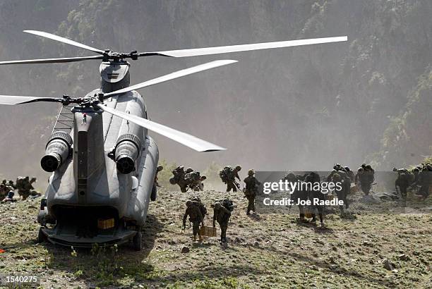 Members of the Princess Patricia's Canadian Light Infantry file into a U.S. Army chinook helicopter May 7, 2002 in the Towr Ghar mountain in the Tora...