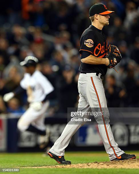 Curtis Granderson of the New York Yankees rounds the bases after hitting a solo home run in the seventh inning against Troy Patton of the Baltimore...