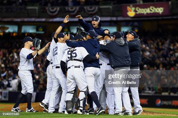 The New York Yankees celebrate after defeating the Baltimore Orioles by a score of 3-1 to win Game Five of the American League Division Series at...
