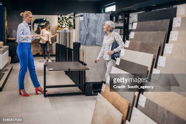 woman shopping for bathroom tiles - tile showroom stock pictures, royalty-free photos & images