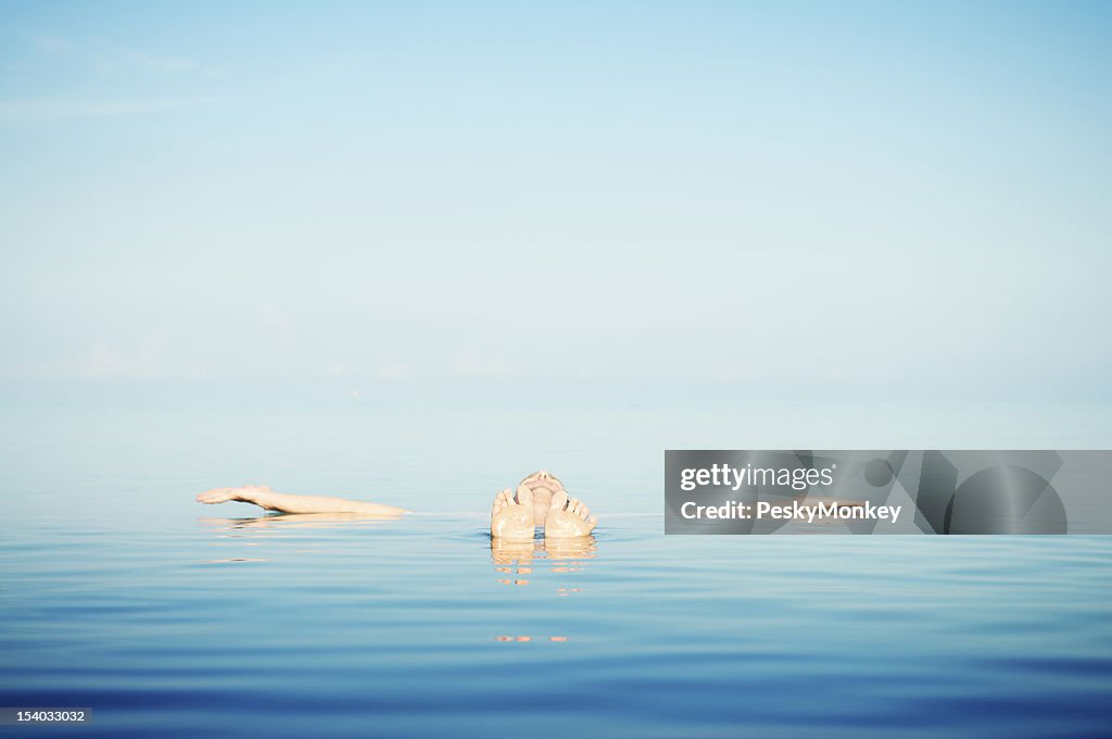 Man Floats in Tranquil Blue Waters