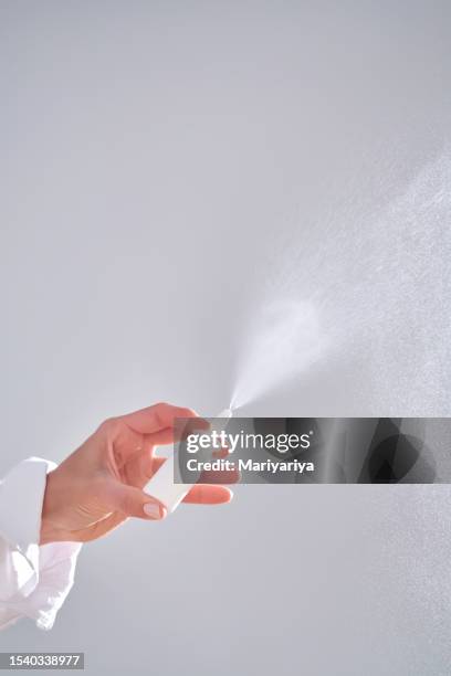 female hands spray a vasoconstrictor nasal spray. - nasal spray stock pictures, royalty-free photos & images