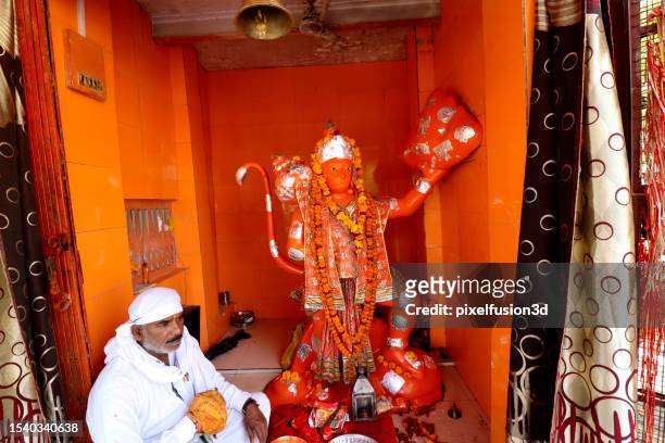 hindu devotee sitting in lord hanumana temple at haridwar, uttrakhand, india. - rishikesh meditation stock pictures, royalty-free photos & images