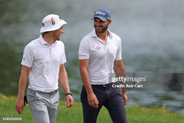 Peter Malnati of the United States and Clement Sordet of France walk to the ninth green during the first round of the Barbasol Championship at Keene...