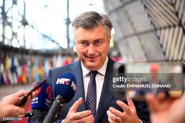 Croatia's Prime Minister Andrej Plenkovic talks to the press as he leaves after attending the plenary session of a summit of the European Union and...