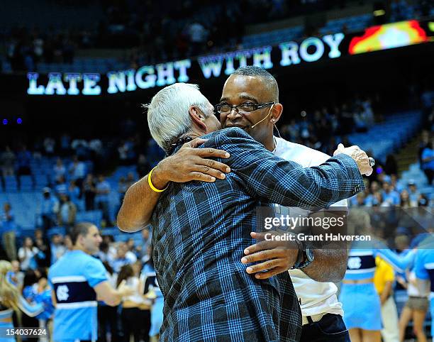 Coach Roy Williams of the North Carolina Tar Heels embraces ESPN anchor Stuart Scott after the team's annual Late Night with Roy season kickoff at...