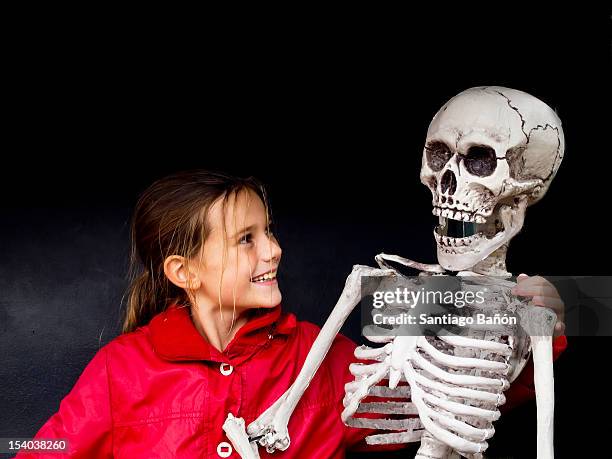 girl smiling at skeleton - funny skeleton stock pictures, royalty-free photos & images